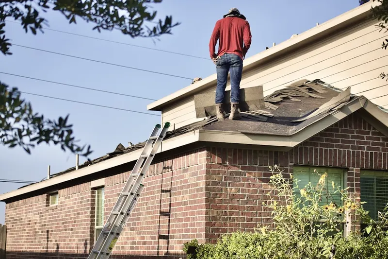 Professional roofer working on a residential roof in Ponderosa Village